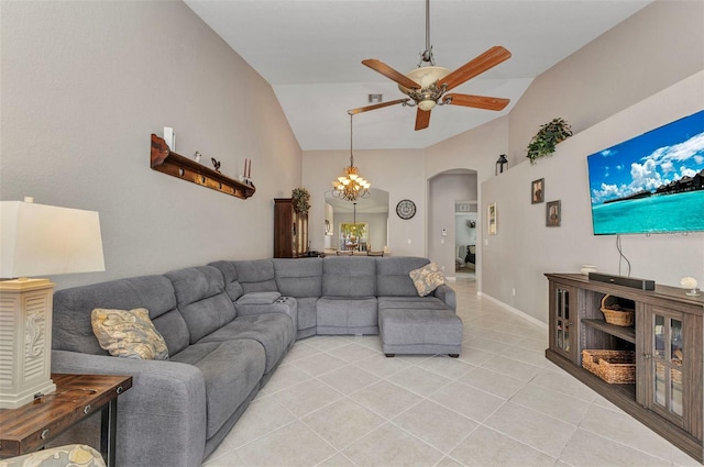 living area with high vaulted ceiling, light tile patterned flooring, arched walkways, and ceiling fan with notable chandelier