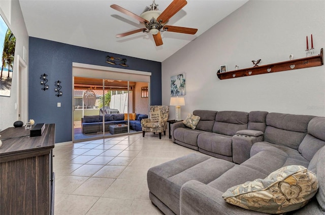 living area featuring lofted ceiling, a ceiling fan, and light tile patterned floors