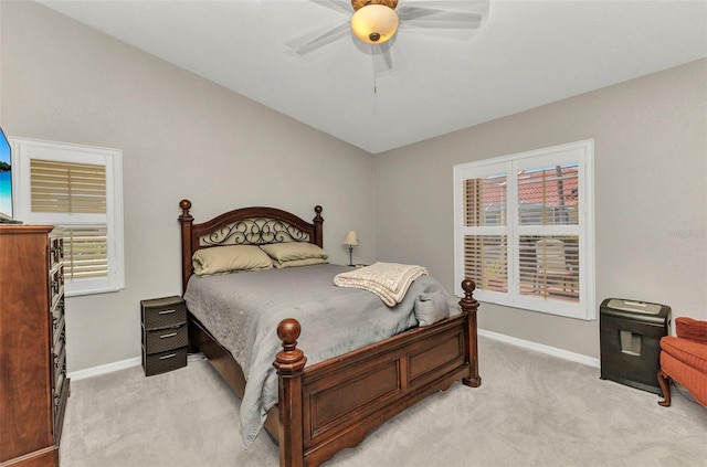 bedroom with baseboards, light carpet, and ceiling fan