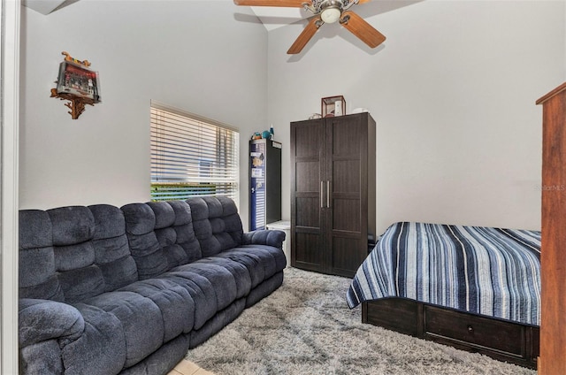 bedroom with ceiling fan and a high ceiling