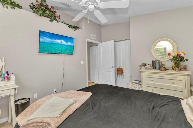 bedroom with lofted ceiling, ceiling fan, a closet, and visible vents