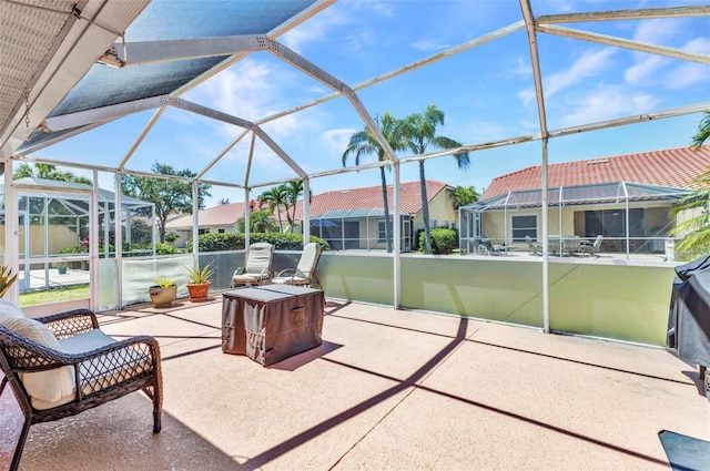 view of patio featuring a lanai