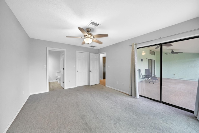 unfurnished bedroom with carpet flooring, baseboards, a ceiling fan, and connected bathroom