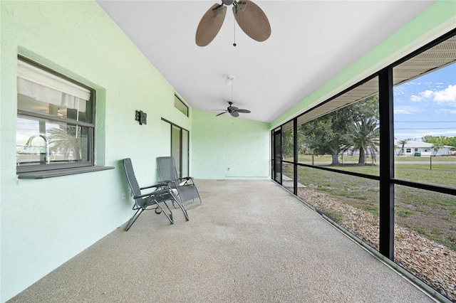 unfurnished sunroom featuring ceiling fan and lofted ceiling
