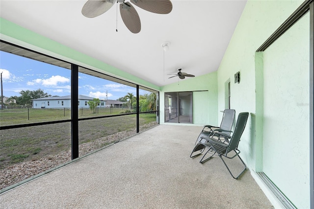 sunroom / solarium featuring ceiling fan and lofted ceiling