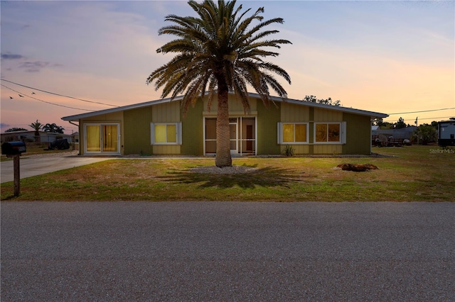 5527 Fairway Dr S, Punta Gorda, FL 33982 - mid-century home featuring concrete driveway and a front yard