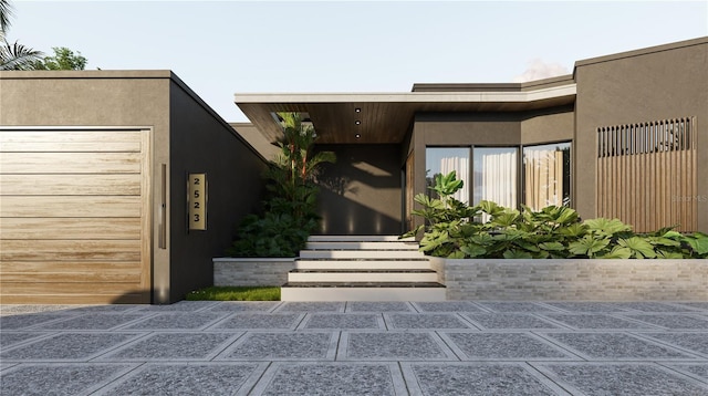 property entrance featuring stucco siding