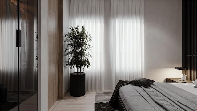 bedroom with wood finished floors and baseboards