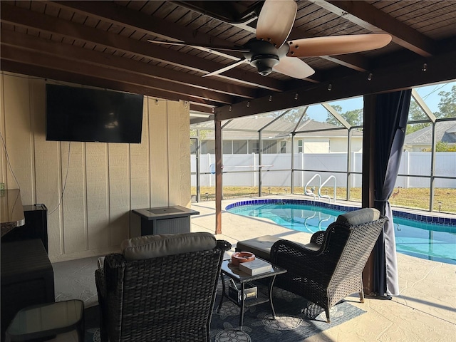 view of swimming pool featuring a fenced in pool, fence, ceiling fan, a patio area, and a lanai