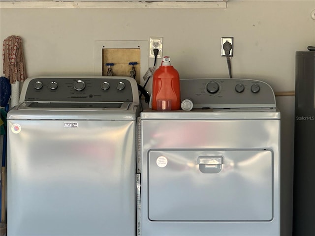 laundry area featuring washing machine and clothes dryer and laundry area