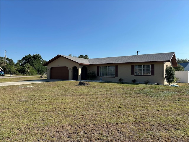 ranch-style house featuring concrete driveway, an attached garage, stucco siding, and a front lawn