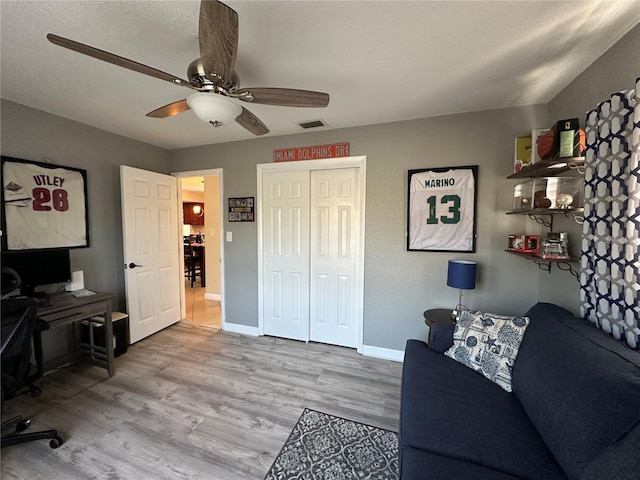 office featuring visible vents, wood finished floors, baseboards, and ceiling fan