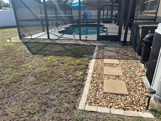 view of swimming pool featuring a patio area, a fenced in pool, a fenced backyard, and a lanai