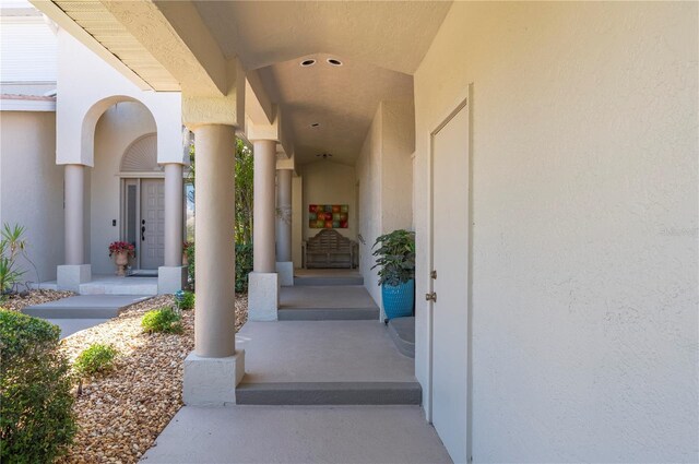 3800 Bal Harbor Blvd Unit 415, Punta Gorda, FL 33950 - doorway to property featuring stucco siding and a porch