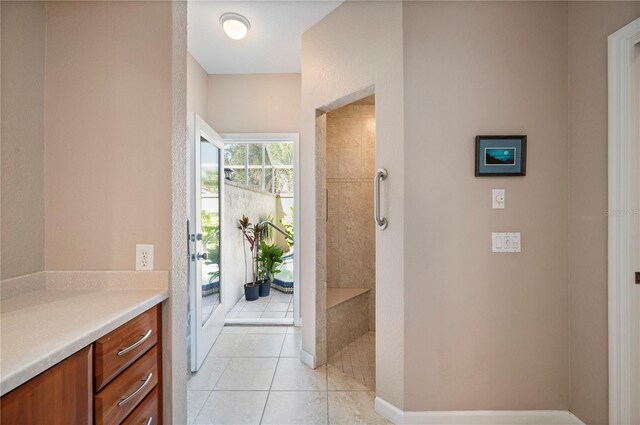 3800 Bal Harbor Blvd Unit 415, Punta Gorda, FL 33950 - bathroom featuring walk in shower, tile patterned flooring, and vanity