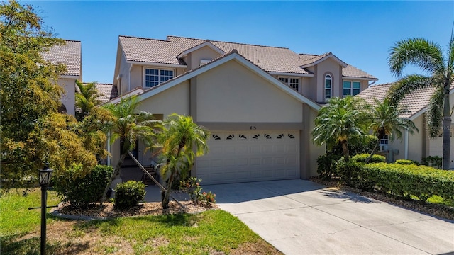 3800 Bal Harbor Blvd Unit 415, Punta Gorda, FL 33950 - view of front of house featuring a tiled roof, stucco siding, an attached garage, and driveway