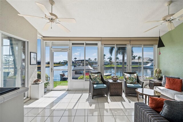 3800 Bal Harbor Blvd Unit 415, Punta Gorda, FL 33950 - sunroom / solarium with a water view, a textured wall, a textured ceiling, healthy amount of natural light, and tile patterned floors