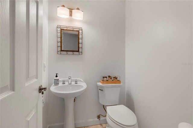 3800 Bal Harbor Blvd Unit 415, Punta Gorda, FL 33950 - bathroom with toilet, a sink, and tile patterned floors