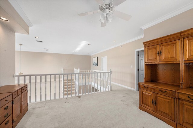 3800 Bal Harbor Blvd Unit 415, Punta Gorda, FL 33950 - unfurnished room featuring light carpet, ceiling fan, baseboards, ornamental molding, and an upstairs landing
