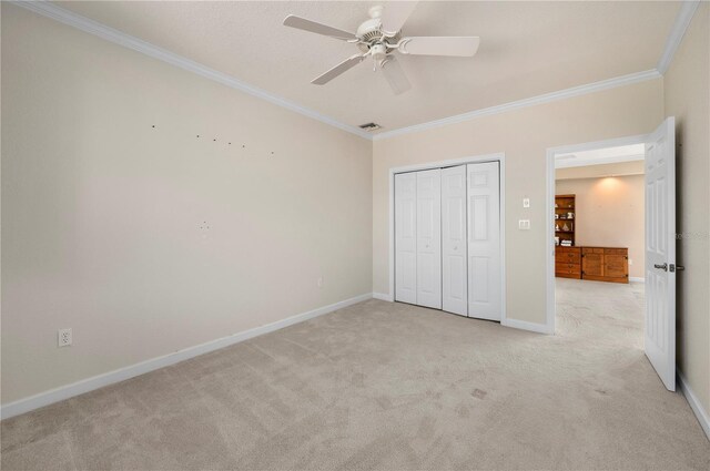3800 Bal Harbor Blvd Unit 415, Punta Gorda, FL 33950 - unfurnished bedroom featuring crown molding, light carpet, a closet, baseboards, and a ceiling fan