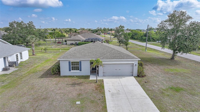 view of front of house featuring roof with shingles, driveway, a garage, stucco siding, and a front yard