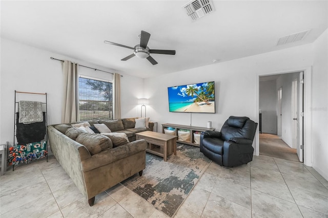 living room featuring light tile patterned floors, ceiling fan, and visible vents