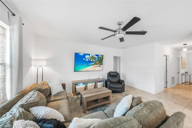 living room with light tile patterned flooring, a ceiling fan, and visible vents