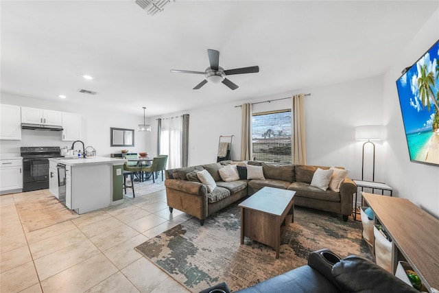 living room featuring light tile patterned floors, a ceiling fan, visible vents, and recessed lighting