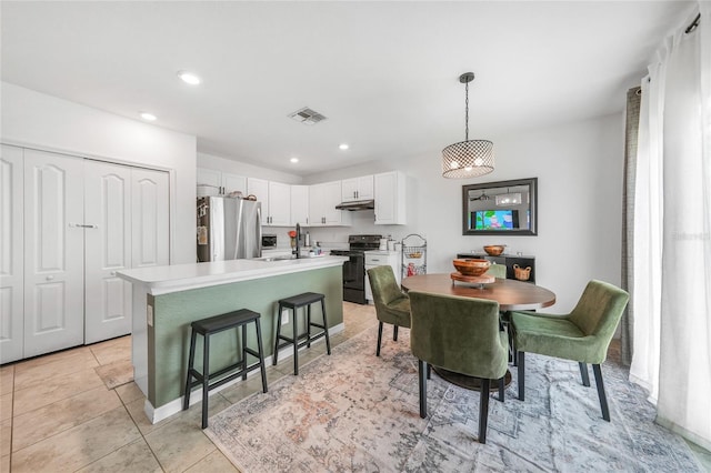 dining area with light tile patterned flooring, visible vents, and recessed lighting