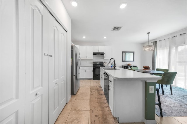 kitchen with a sink, white cabinets, visible vents, black appliances, and light countertops