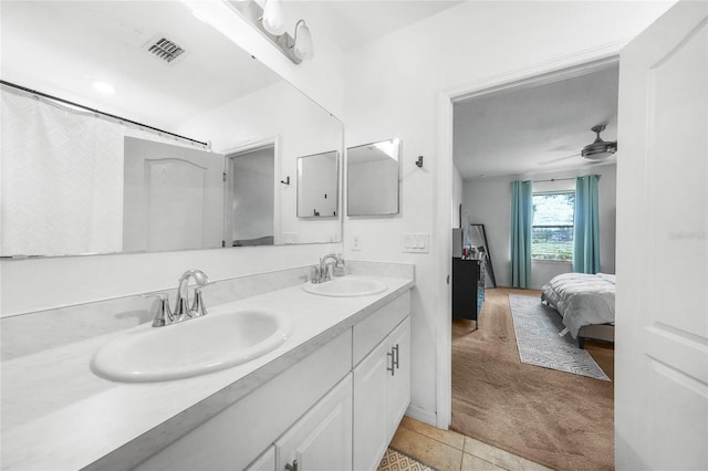 ensuite bathroom featuring a sink, double vanity, ensuite bath, and tile patterned flooring