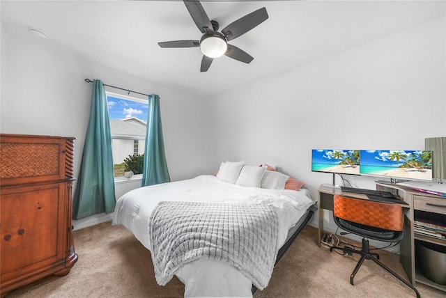 bedroom with light carpet and a ceiling fan