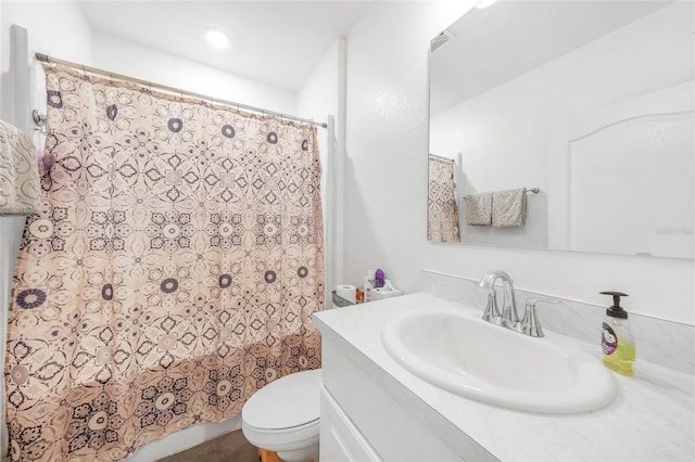full bath featuring toilet, a shower with shower curtain, and vanity