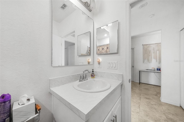 bathroom with vanity and visible vents