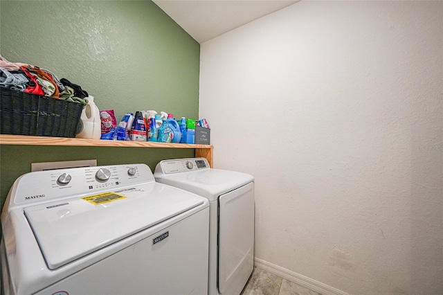 laundry area with independent washer and dryer, baseboards, and laundry area
