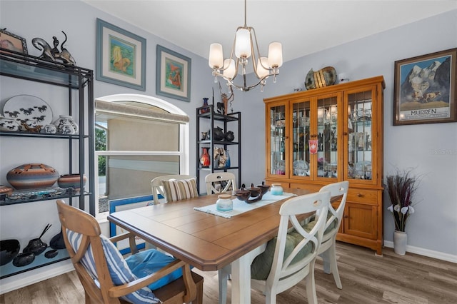 2911 Riverside Dr, Punta Gorda, FL 33950 - dining room featuring a chandelier, light wood finished floors, and baseboards
