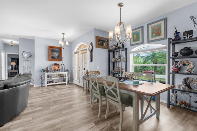 2911 Riverside Dr, Punta Gorda, FL 33950 - dining room with a chandelier, light wood finished floors, french doors, and baseboards