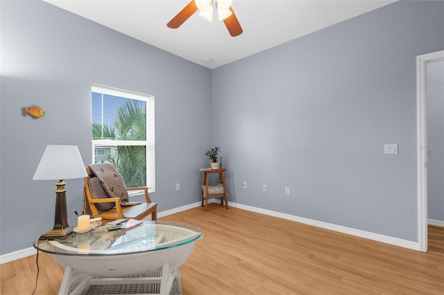 2911 Riverside Dr, Punta Gorda, FL 33950 - living area featuring light wood finished floors, a ceiling fan, and baseboards