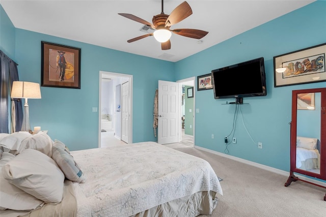 2911 Riverside Dr, Punta Gorda, FL 33950 - carpeted bedroom with baseboards, connected bathroom, and ceiling fan