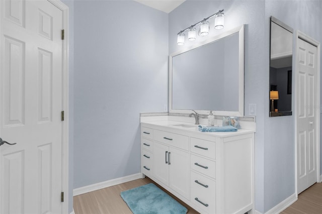2911 Riverside Dr, Punta Gorda, FL 33950 - bathroom featuring wood finished floors, baseboards, and vanity