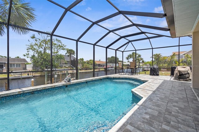 2911 Riverside Dr, Punta Gorda, FL 33950 - outdoor pool featuring a water view, a patio area, and glass enclosure