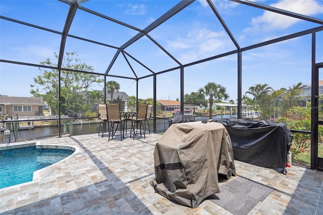 2911 Riverside Dr, Punta Gorda, FL 33950 - view of patio / terrace with a lanai, a dock, a water view, a grill, and an outdoor pool