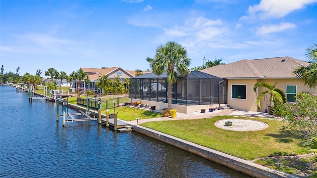 2911 Riverside Dr, Punta Gorda, FL 33950 - back of property with boat lift, a water view, a lawn, and stucco siding