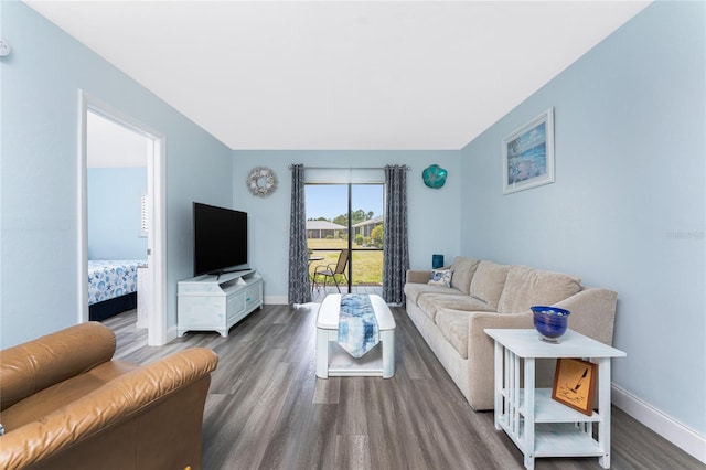 living room featuring wood finished floors and baseboards