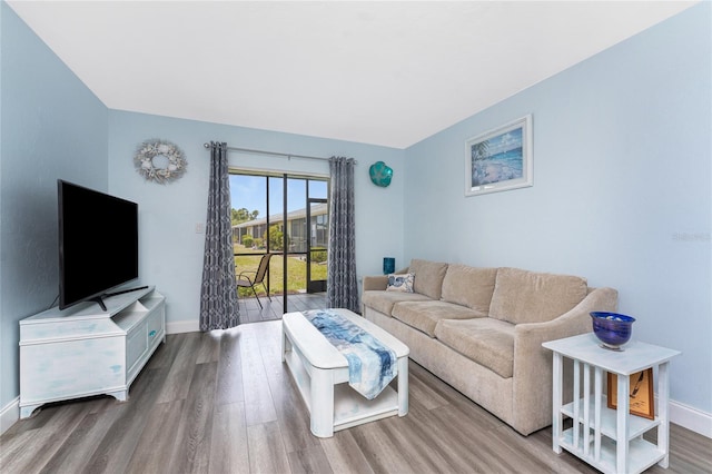 living room featuring baseboards and wood finished floors