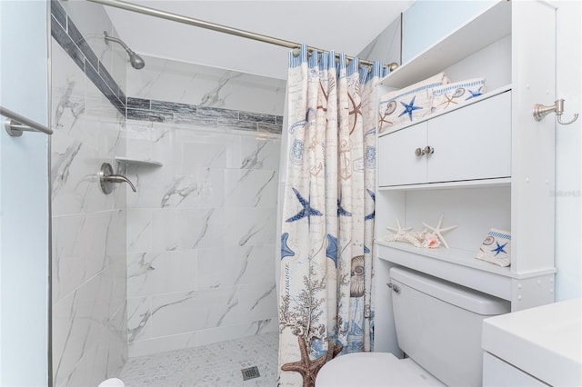 bathroom featuring vanity, toilet, and a shower stall