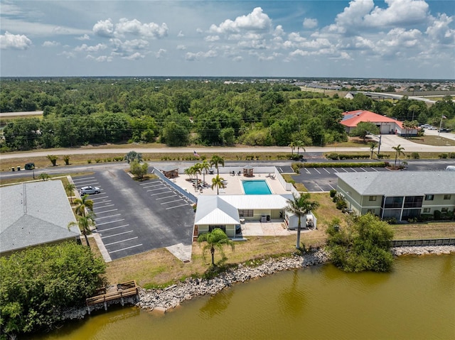 aerial view with a forest view and a water view