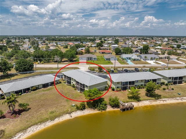 birds eye view of property featuring a water view and a residential view