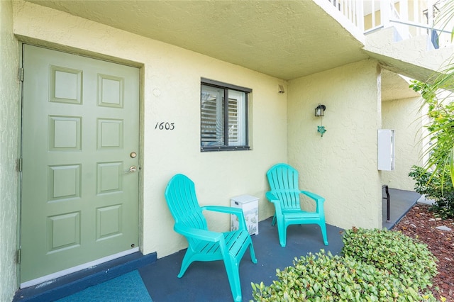 entrance to property with stucco siding