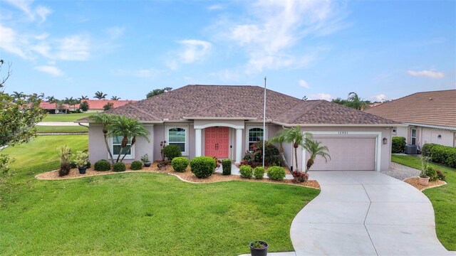 12951 SW Kingsway Cir, Lake Suzy, FL 34269 - single story home with stucco siding, a front yard, an attached garage, and driveway